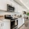 a kitchen with white cabintery